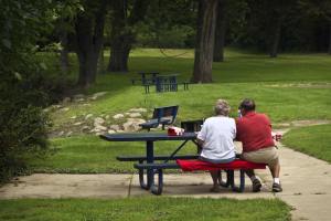 An elderly couple enjoy an intimate lunch at Ferguson Park in Okemos, Michigan.