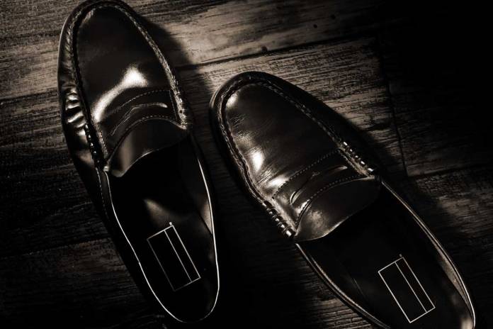 Photograph of worn, but polished penny loafers.