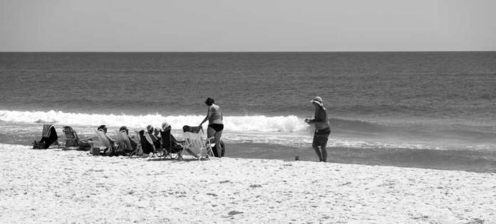 Family enjoying the Gulf of Mexico beach at Gulf Shores, Alabama, USA.